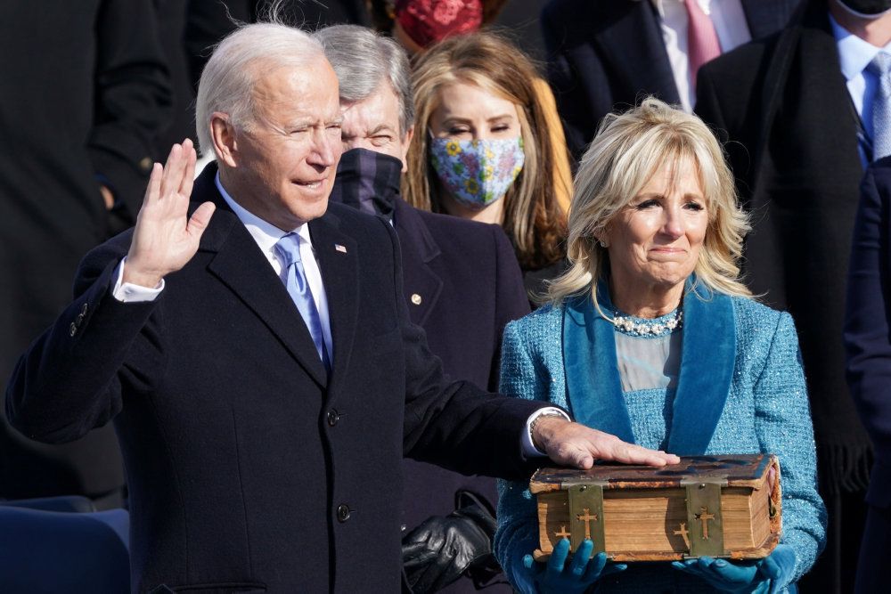Joe Biden is sworn in as the 46th President of the United States as his wife Jill Biden holds a bible on the West Front of the U.S. Capitol in Washington, U.S., January 20, 2021. REUTERS/Kevin Lamarque TPX IMAGES OF THE DAY